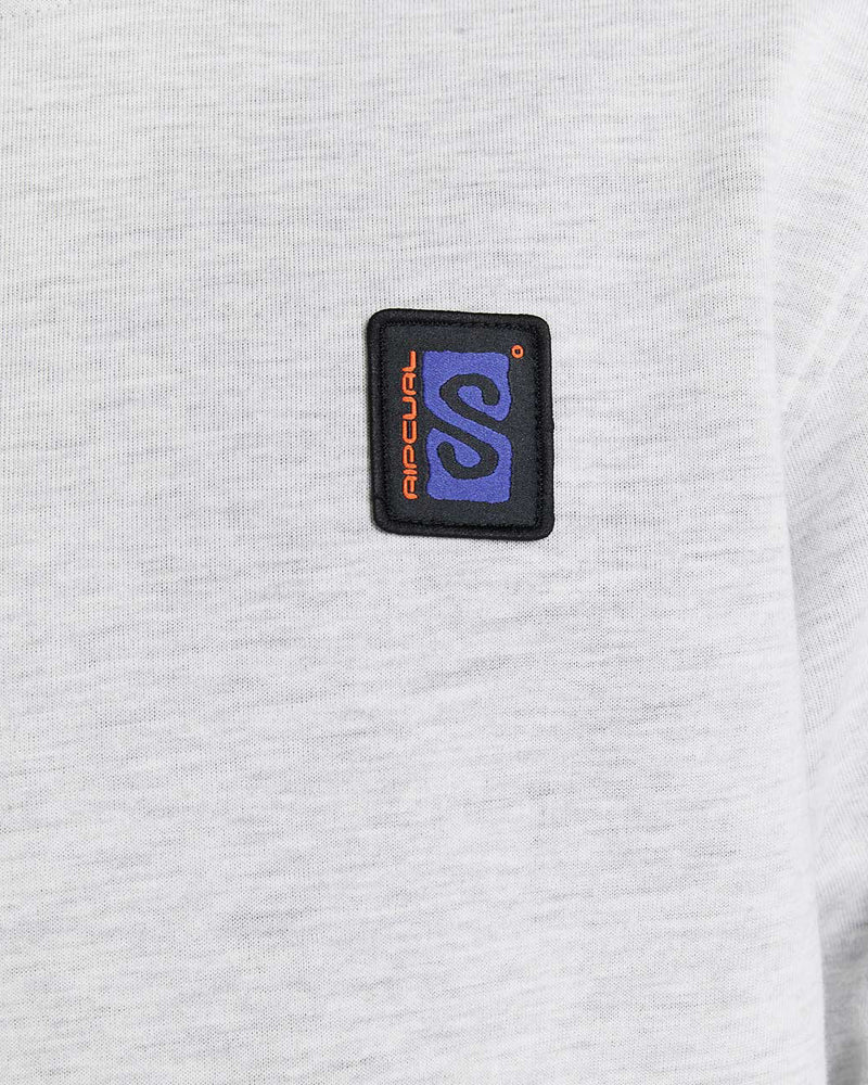 Close-up of Rip Curl patch logo in purple, black, and orange on a light grey textured hoodie fabric.