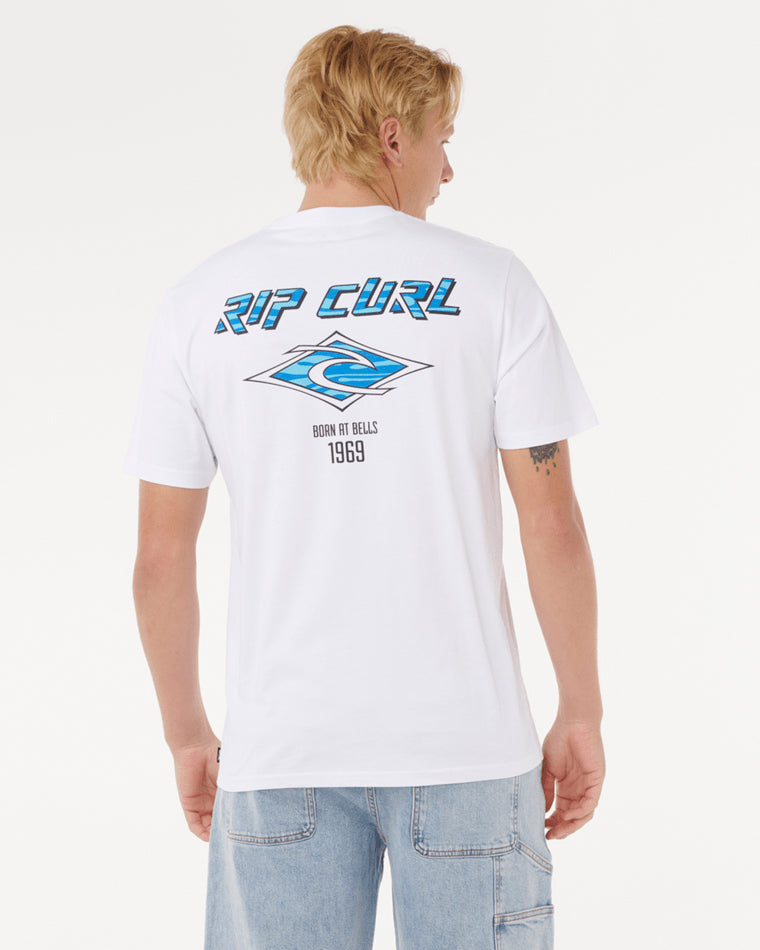 Back view of a white Rip Curl t-shirt featuring a bold blue logo, graphic wave design, and 'Born at Bells 1969' text.