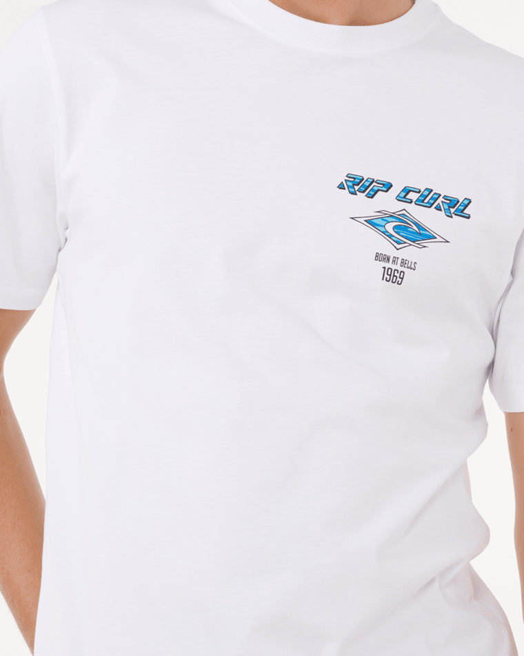 Close-up view of a white Rip Curl t-shirt featuring a blue and black logo design on the chest with 'Born at Bells 1969' text.