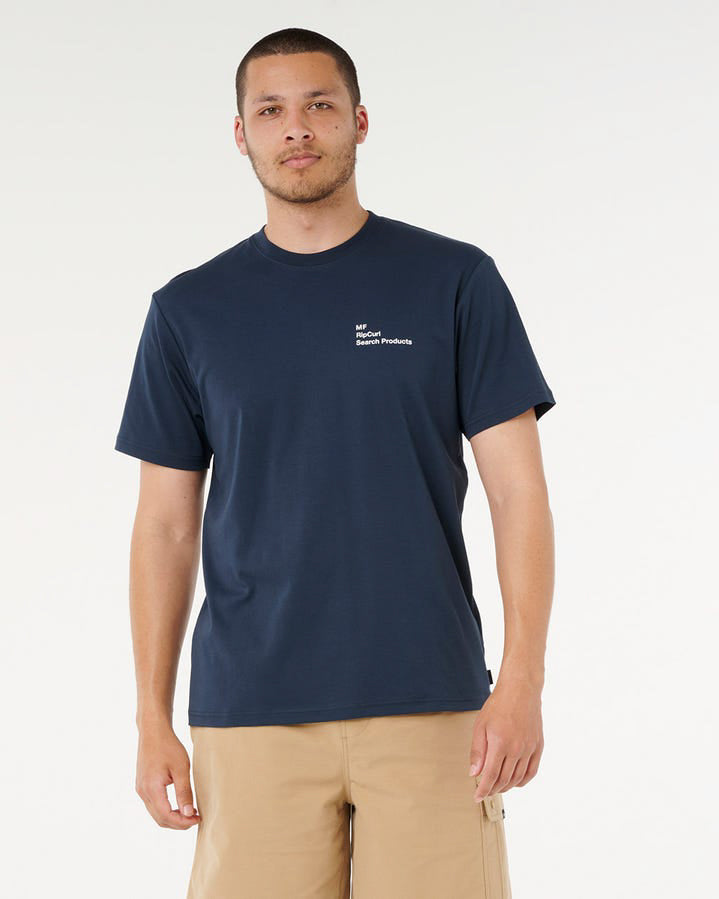 Men's navy Rip Curl tee with small chest print, styled with tan shorts.