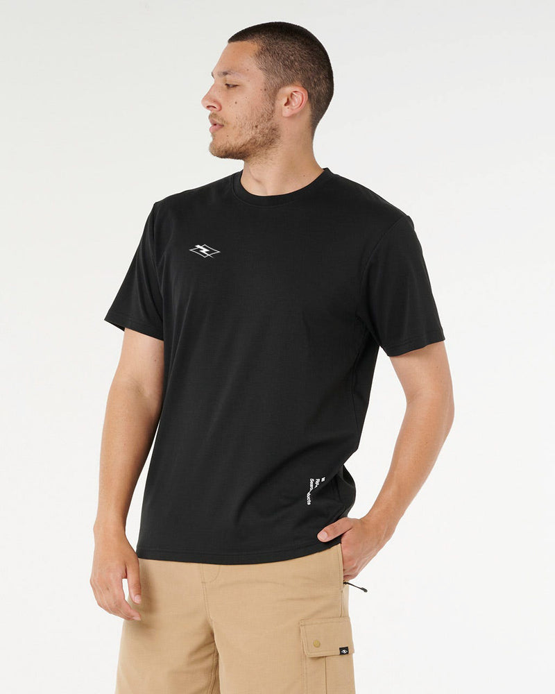 Side angle of black tee with small white logo and beige cargo shorts, relaxed fit with clean minimalist style.