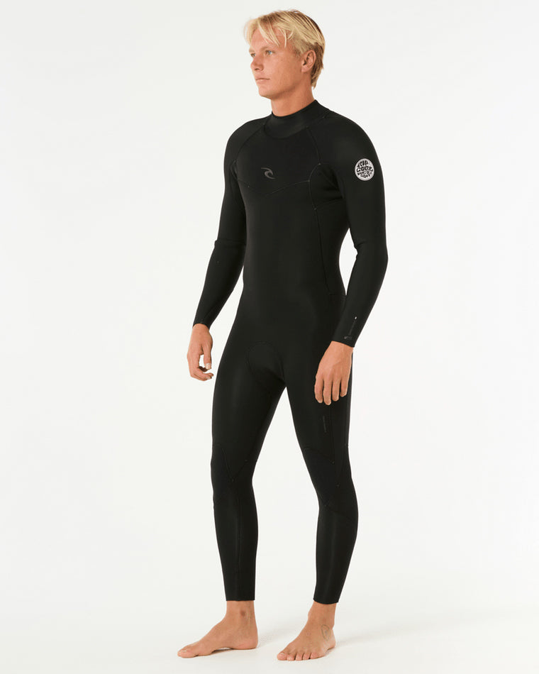 Male model wearing a black full-length Rip Curl wetsuit with long sleeves, featuring a logo on the chest and left arm.