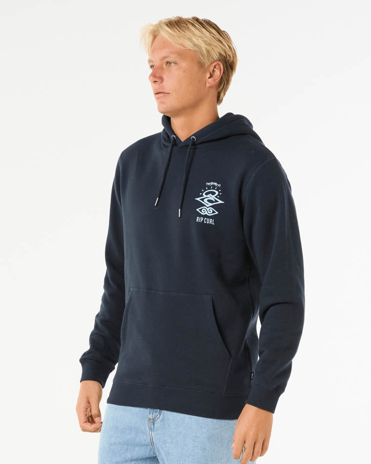 Man wearing a navy Rip Curl hoodie with a small white chest graphic, kangaroo pocket, and drawstring hood.