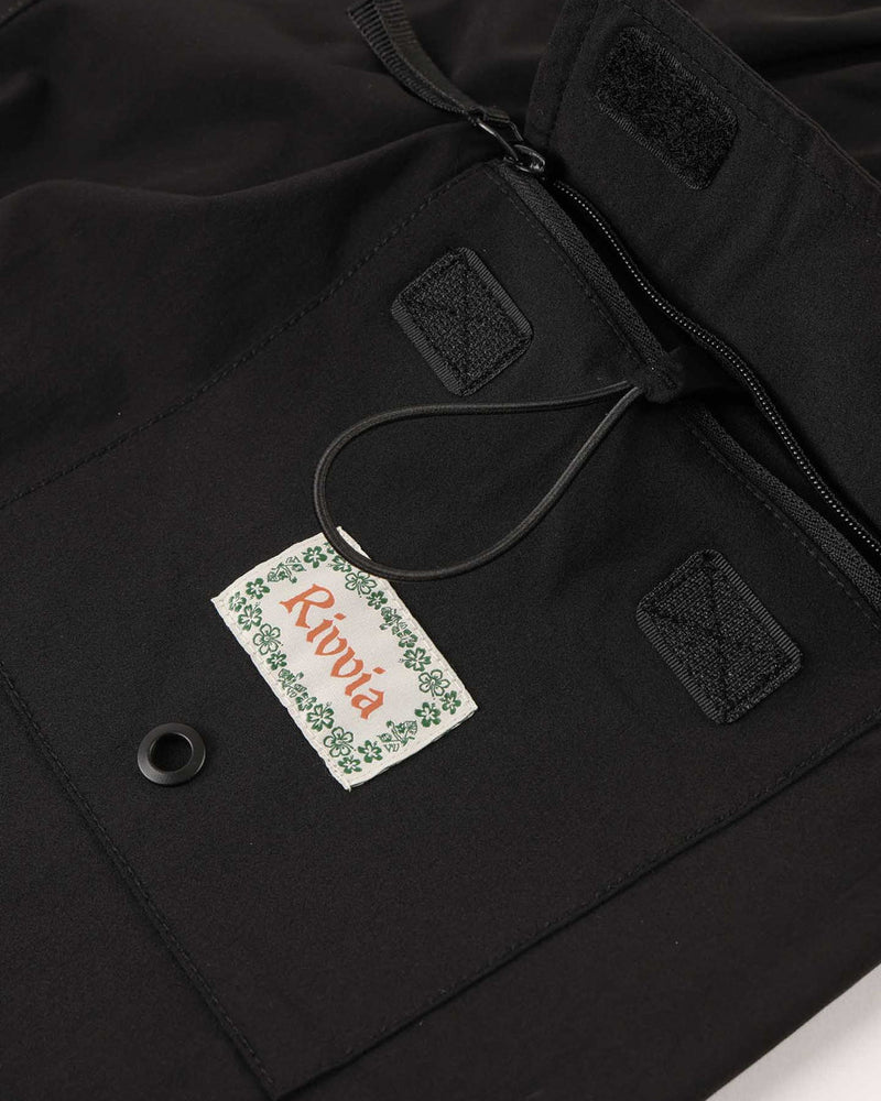 Detail of back pocket with Rivvia patch and drawcord feature