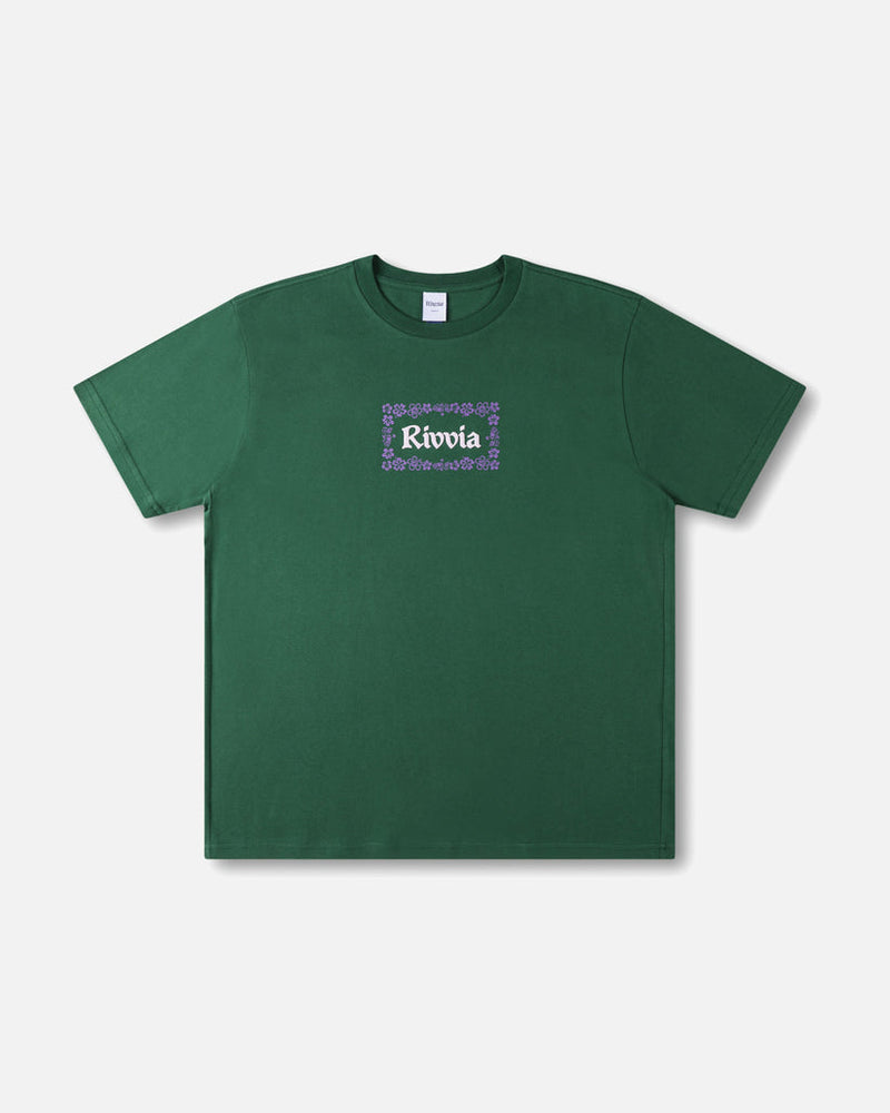 Green t-shirt with Rivvia logo and purple floral border on chest, short sleeves and crew neck