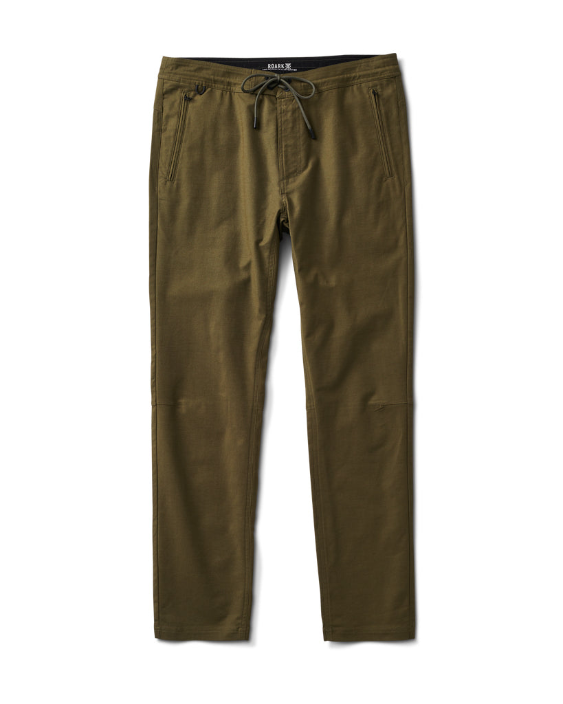Flat-lay of olive green slim-fit pants with drawstring waist, zippered front pockets, and subtle knee panel details.