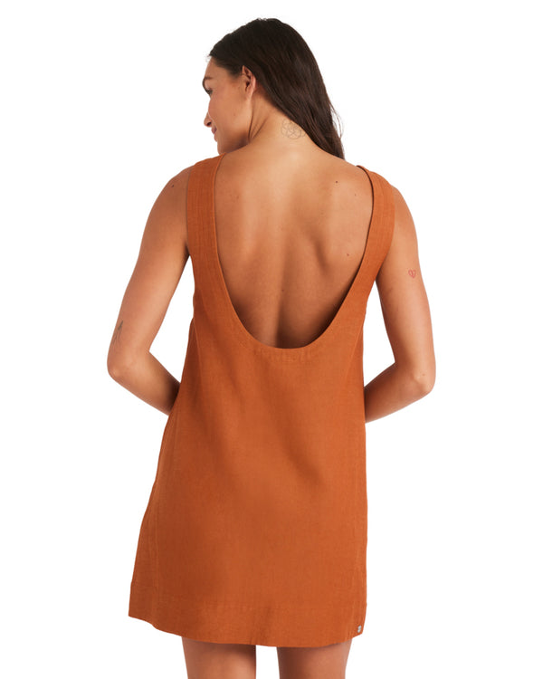 Back view of rust mini dress featuring a deep scoop back and wide straps.