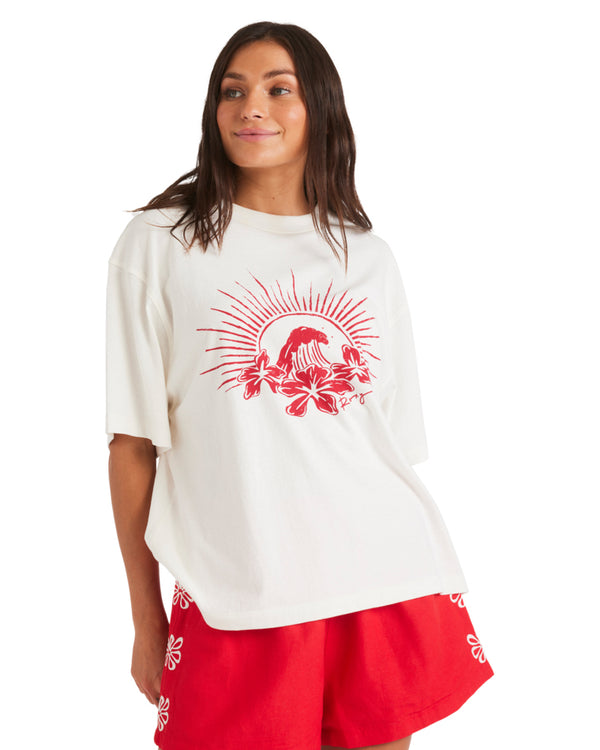 Oversized white t-shirt with red wave and hibiscus graphic on front, paired with red shorts.