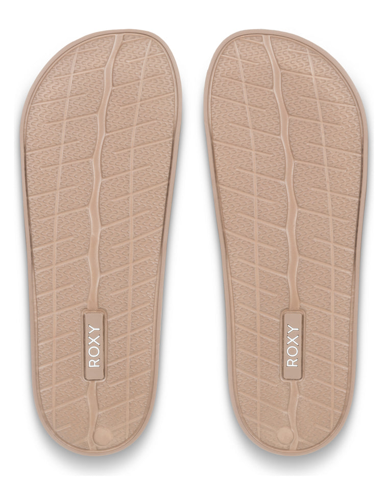 Outsole view of nude Roxy slides with textured grip and branded sole detail