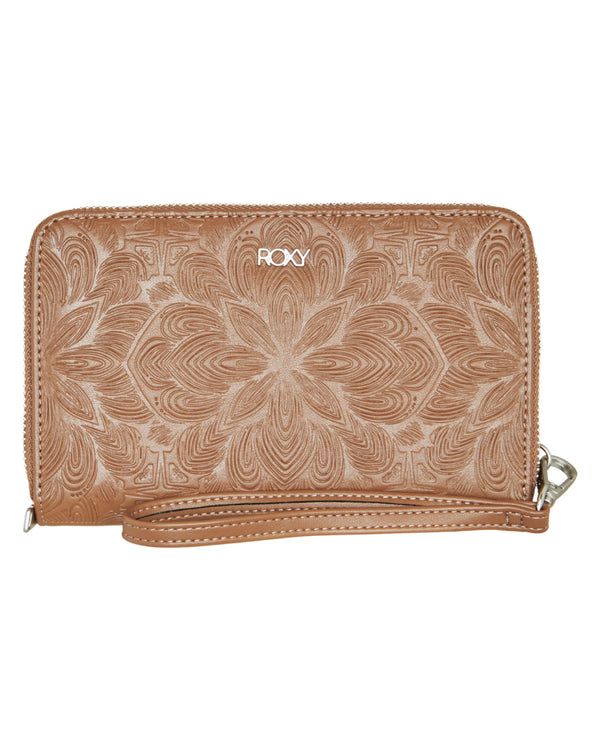 Tan Roxy wallet with embossed floral pattern and detachable wrist strap.