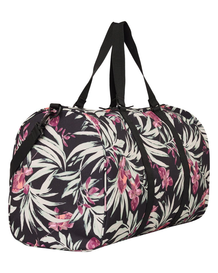 Angled view of large floral Roxy duffle bag with sturdy black straps.