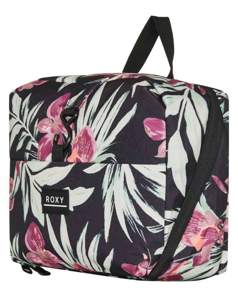 Angled view of Roxy floral pouch showing logo, clip, and curved zip shape