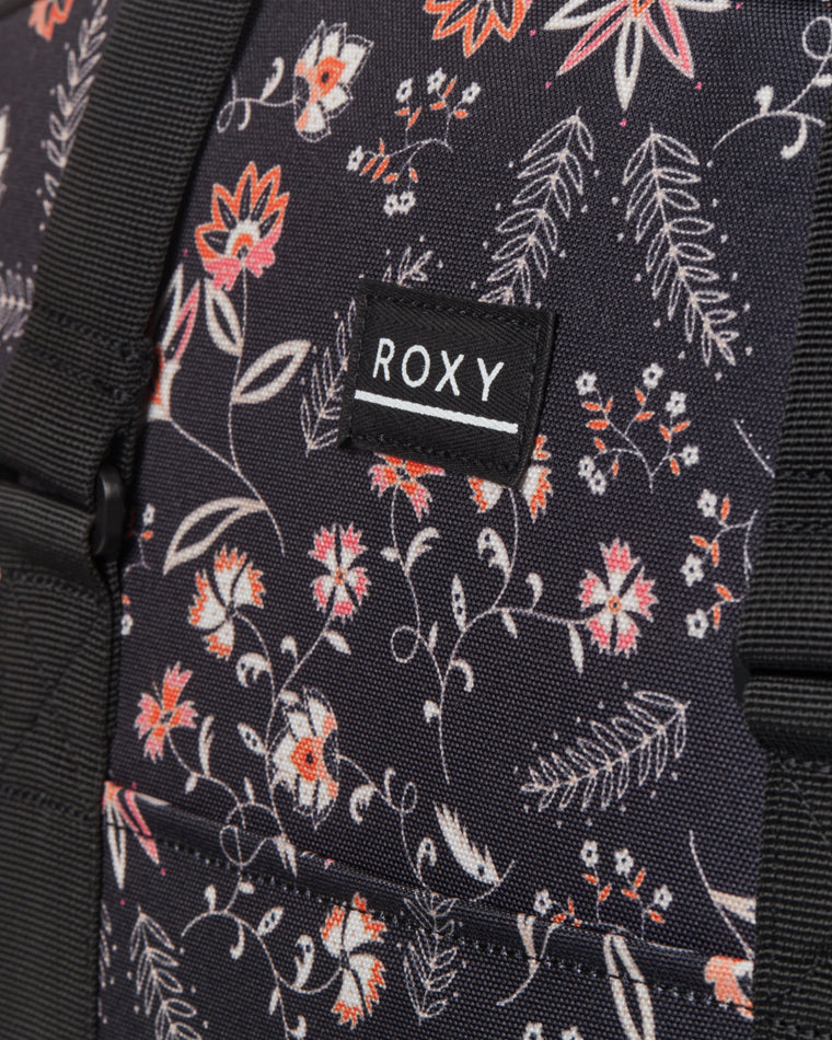 Close-up view of Roxy floral-print duffle bag, highlighting the fabric texture, floral pattern, and Roxy logo patch.