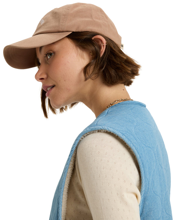 Side view of the cap being worn, showing the curved brim and adjustable back.