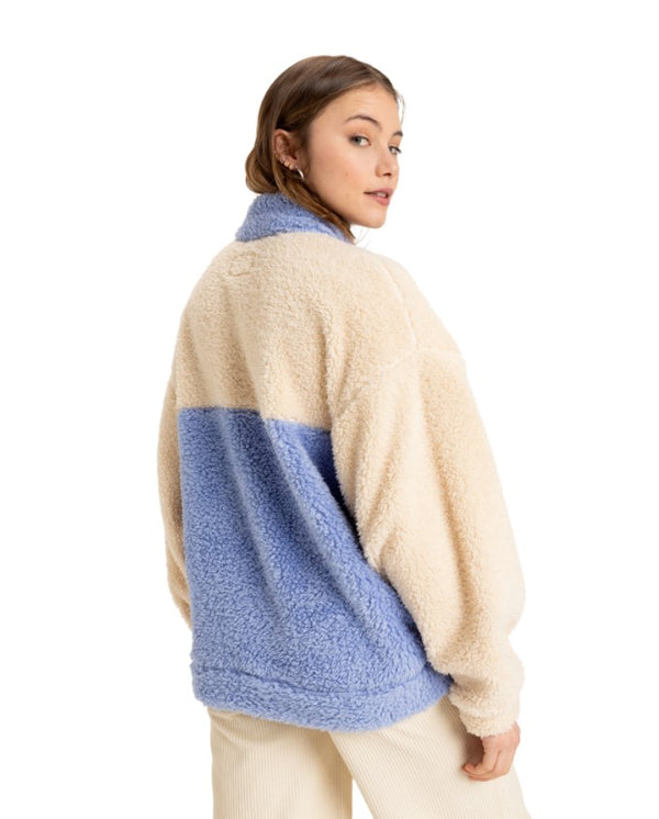 Back view of a color-block fleece pullover featuring cream and light blue panels, a relaxed fit, and a cozy texture.