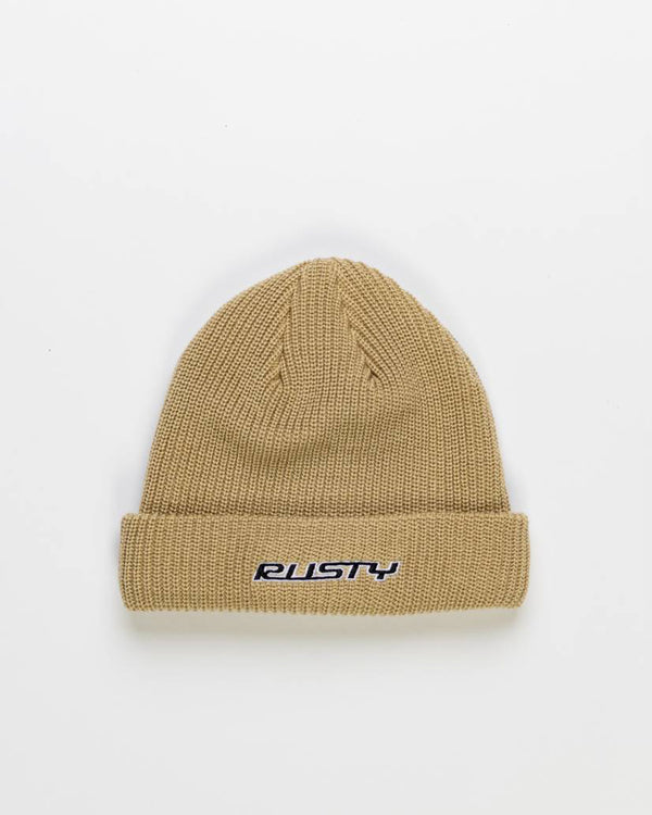 Beige knitted beanie with a folded cuff, featuring the 'Rusty' logo embroidered in black and white on the front.