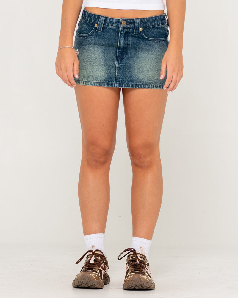 Front view of blue denim mini skirt with faded wash and classic five pocket design