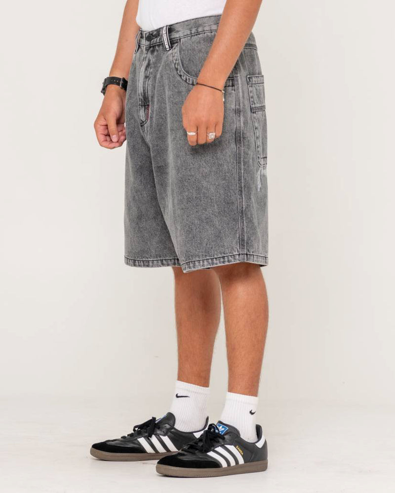 Side view of men's grey washed denim shorts with a relaxed fit, side pocket detail, and subtle distressing.