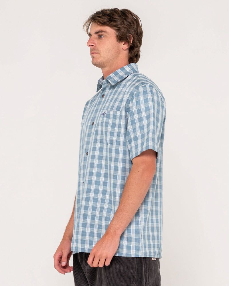 Side view of blue check short sleeve shirt featuring button-up front and soft cotton fabric