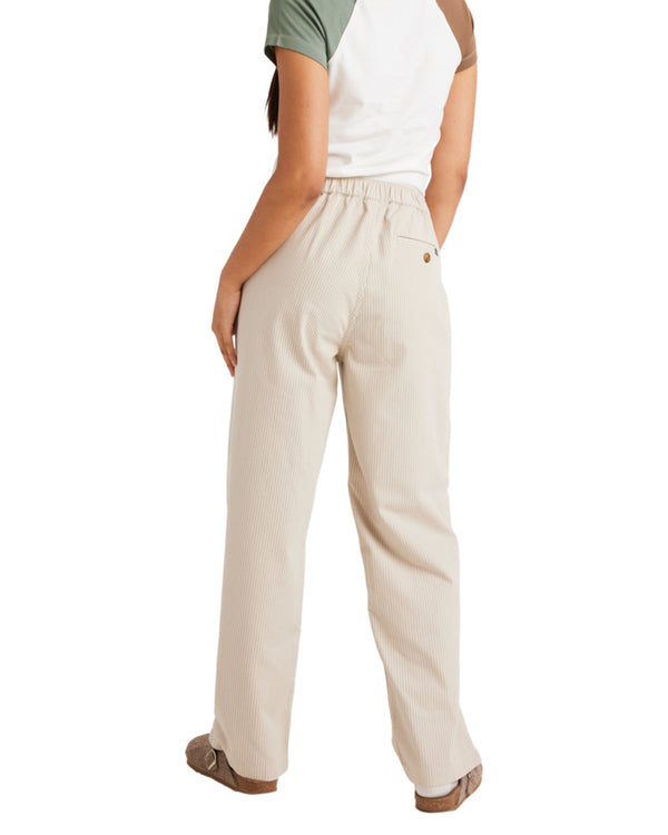 Back view of beige stripe pants with an elastic waistband, single back pocket, and relaxed fit, styled with casual shoes.