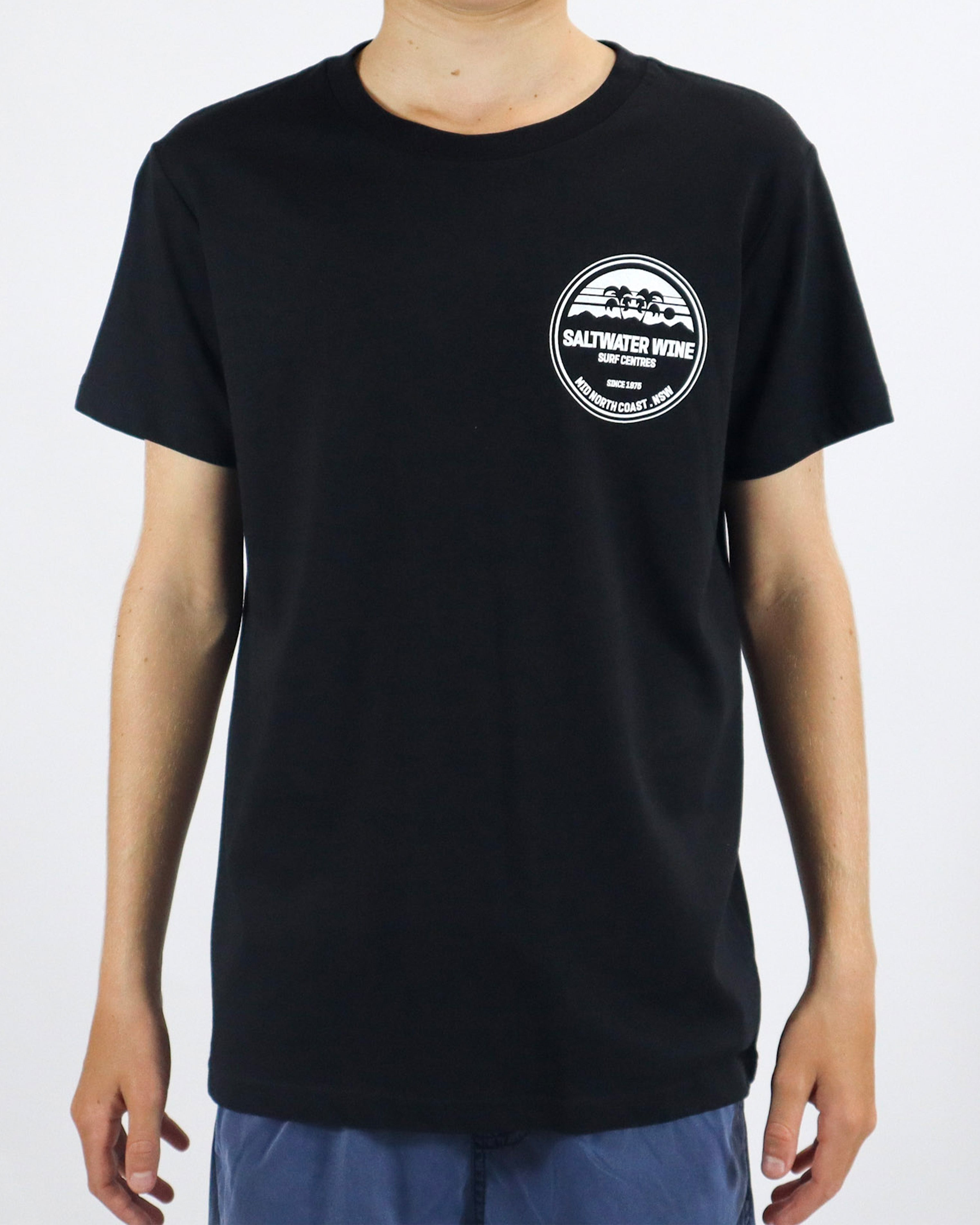 Black Saltwater Wine tee with white logo print on chest, worn with blue shorts.