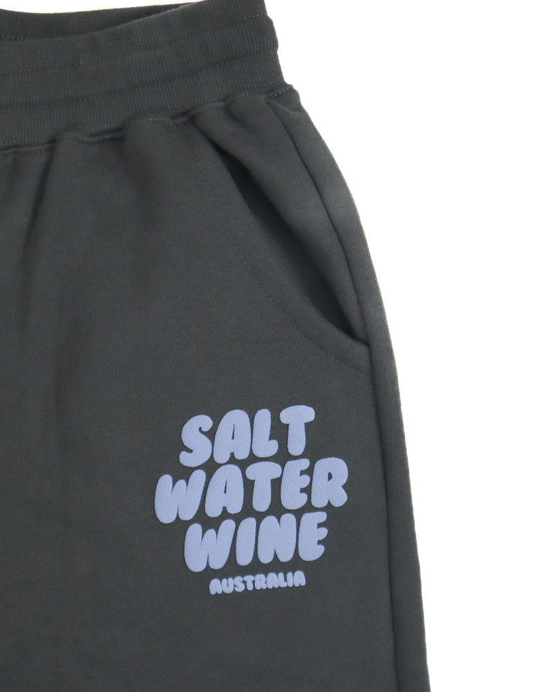 Close-up of Salt Water Wine Australia logo in lilac on charcoal fleece trackpants