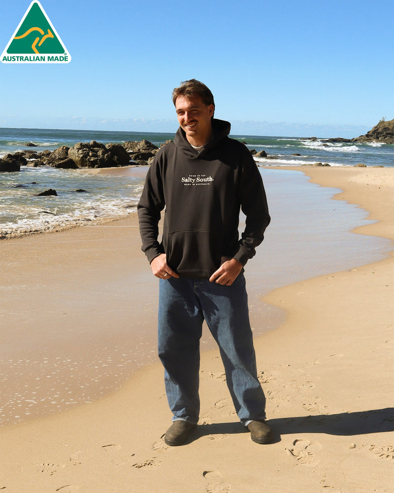 Men’s black Salty South hoodie with front pouch pocket and white logo, made in Australia for everyday coastal wear.