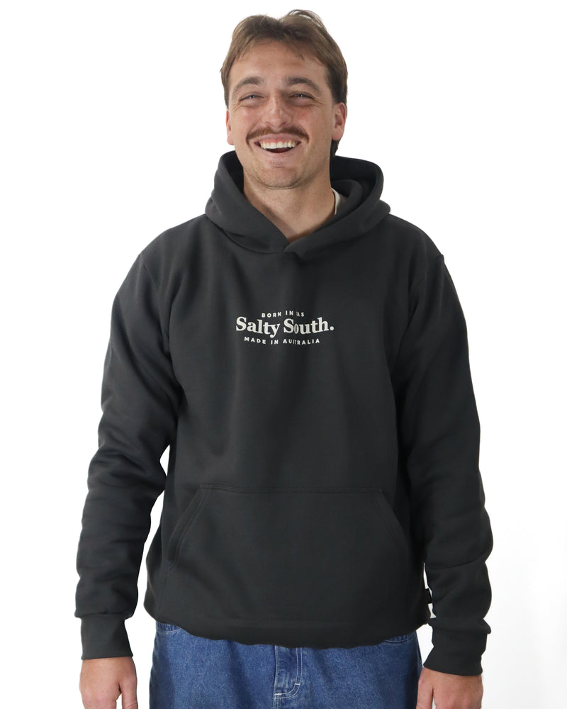 Studio shot of men’s black Salty South hoodie with Born in TAS, Made in Australia print and relaxed fit.