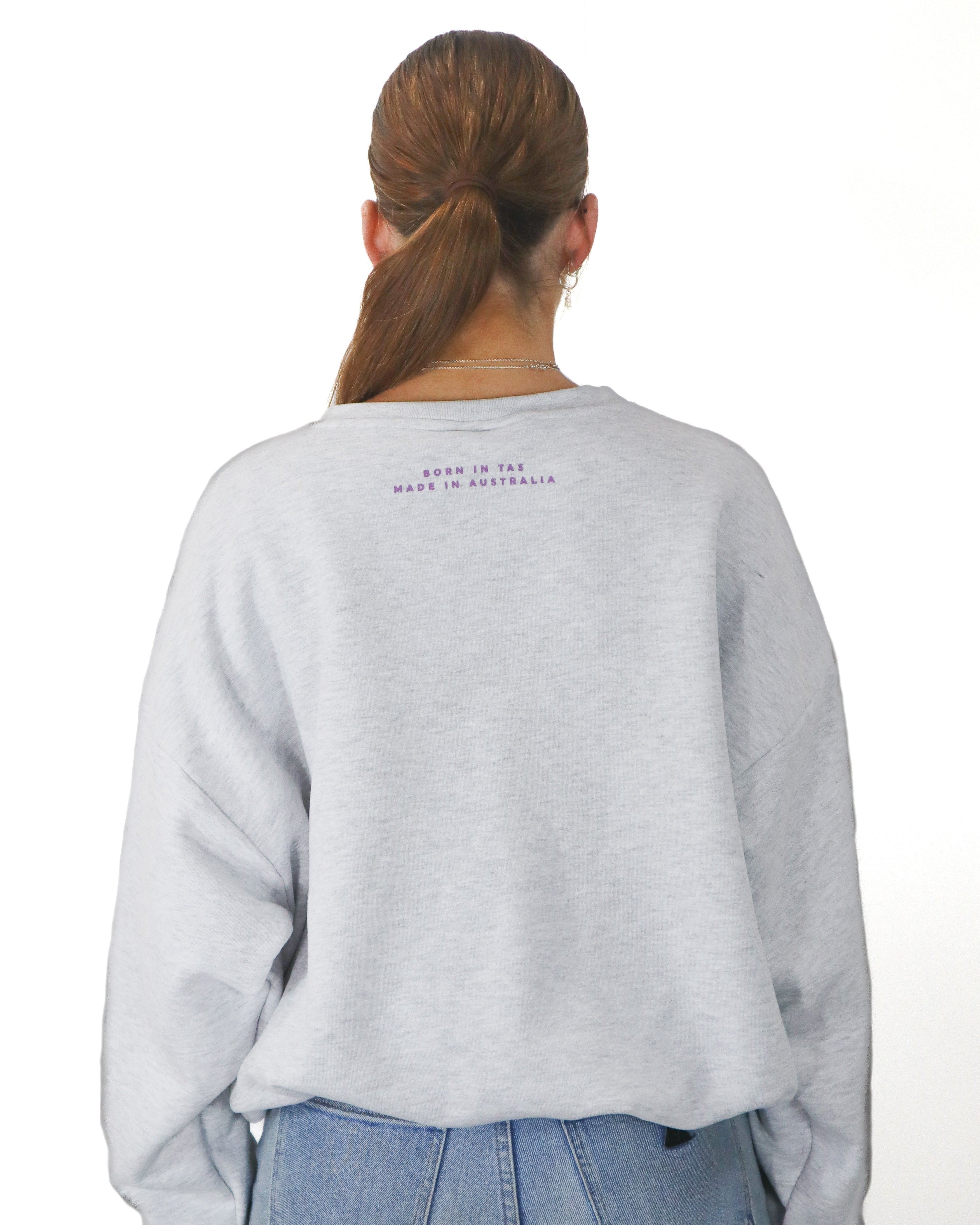 Back view of grey Salty South jumper featuring ‘Born in TAS, Made in Australia’ text beneath the neckline.