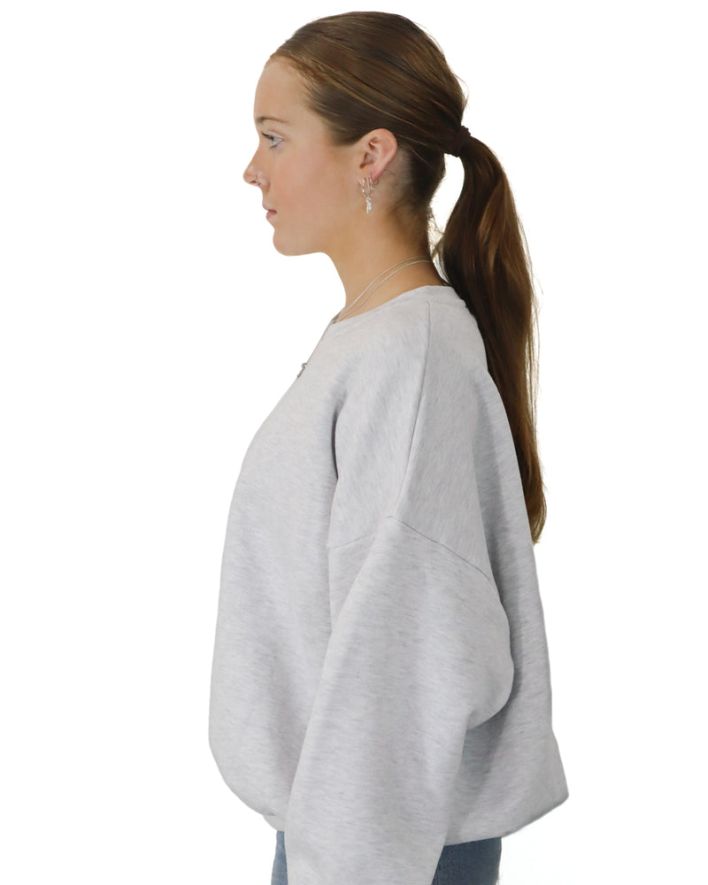 Side view of grey Australian made Salty South crew neck jumper with dropped shoulder and relaxed fit.