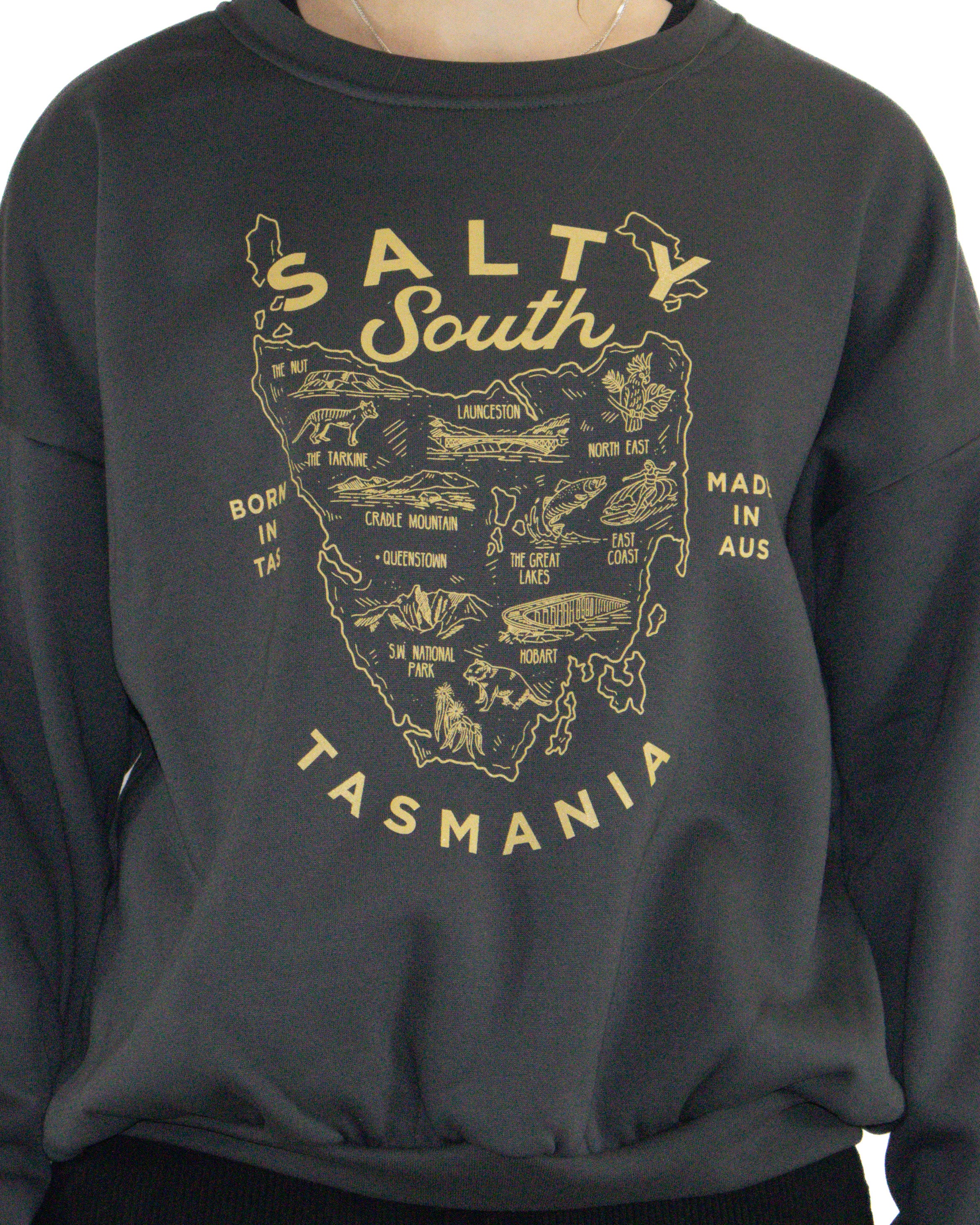 Close-up of Salty South Tasmania print in yellow on charcoal sweatshirt.