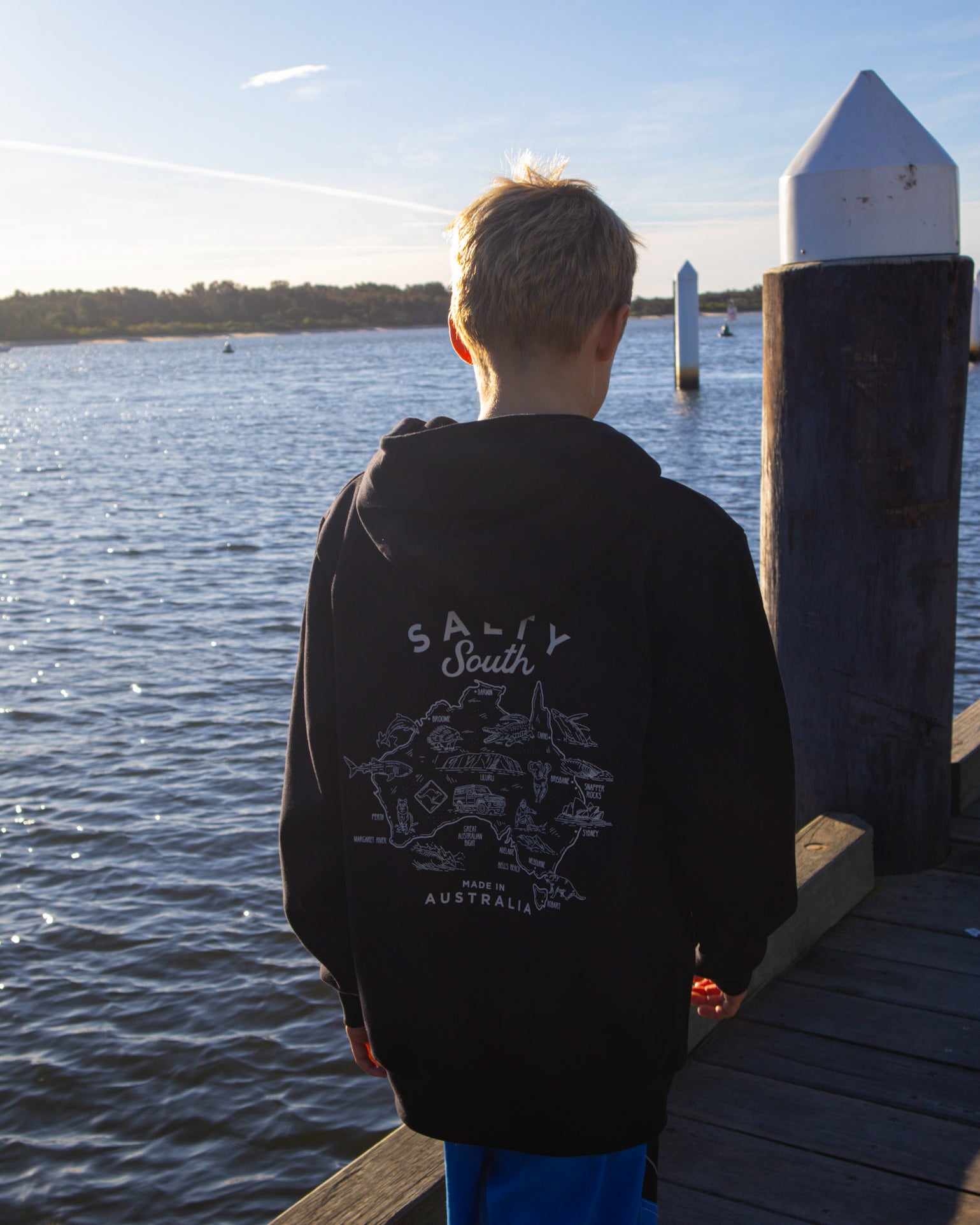 Back view of kids Salty South hoodie featuring detailed Australia map print and white logo design, made in Australia.