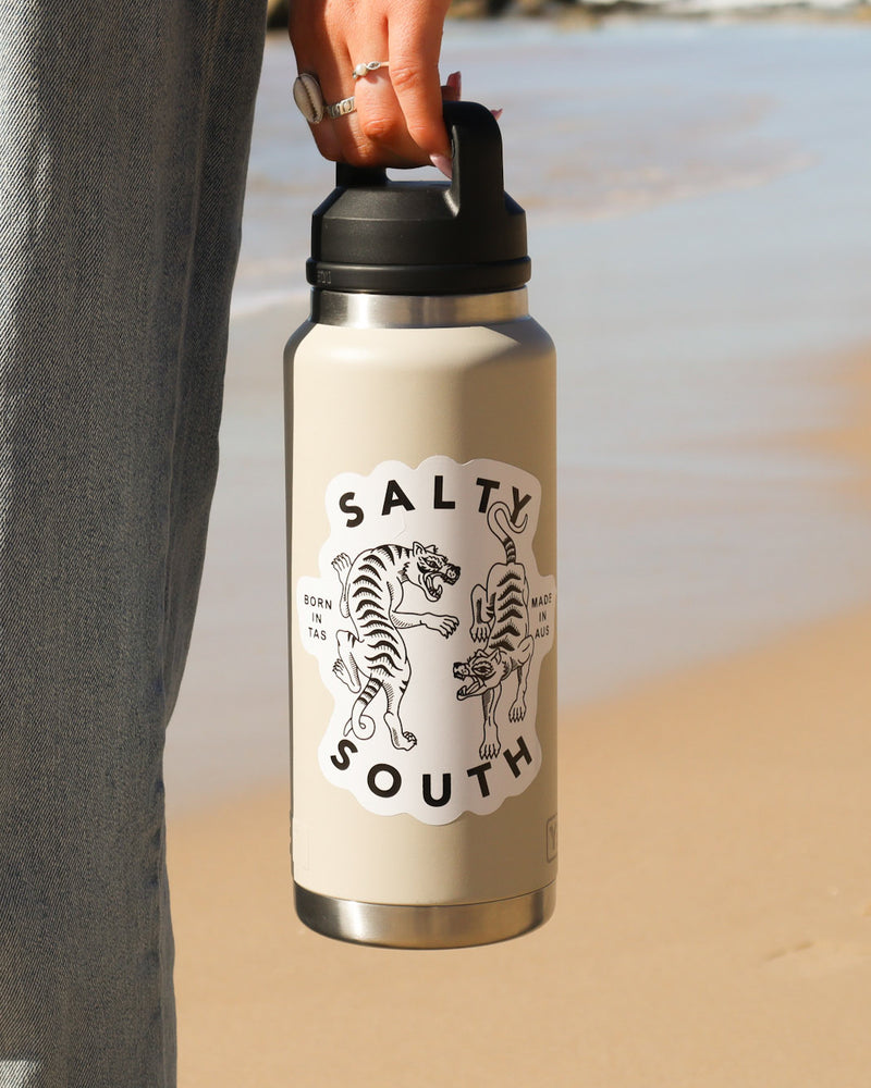 Salty South insulated drink bottle in cream with black lid, featuring tiger graphic and ‘Born in TAS, Made in AUS’ text.
