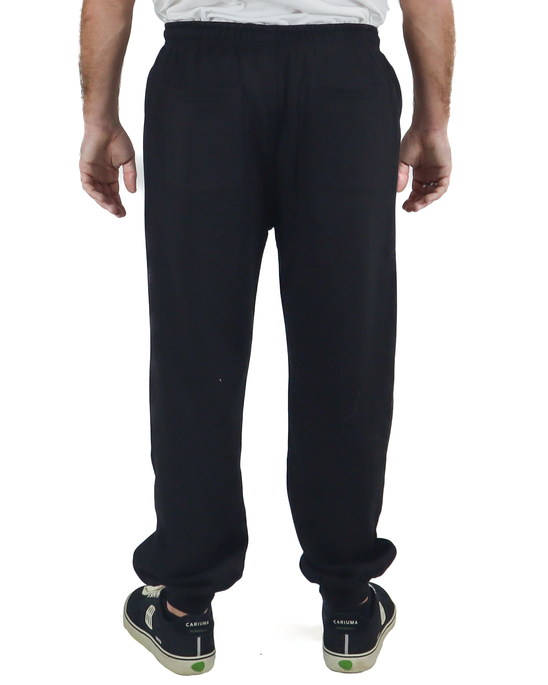 Back view of men's black fleece trackpants with elastic waistband and relaxed fit