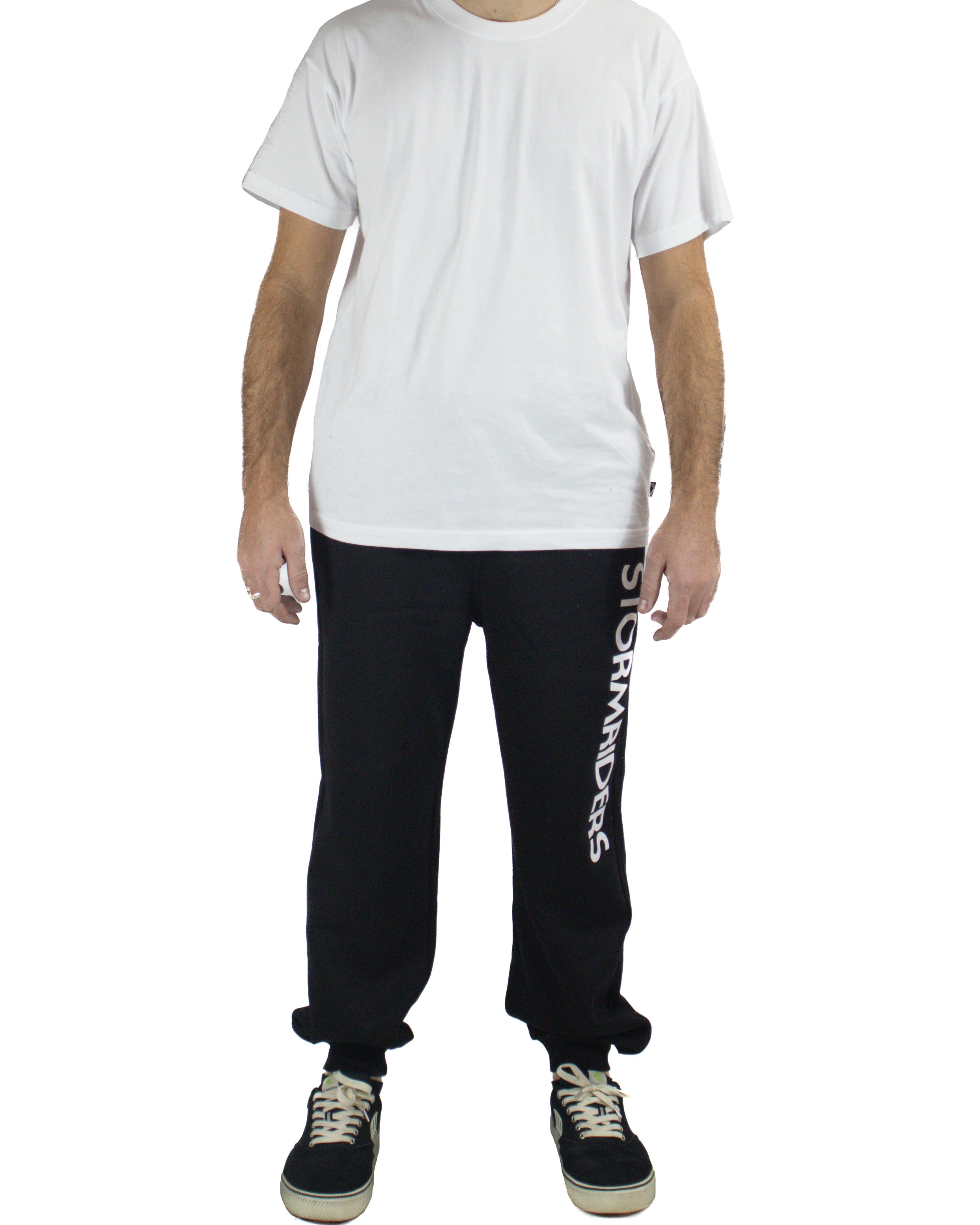 Men's black trackpants with Stormriders logo on leg, paired with white tee and sneakers, front view