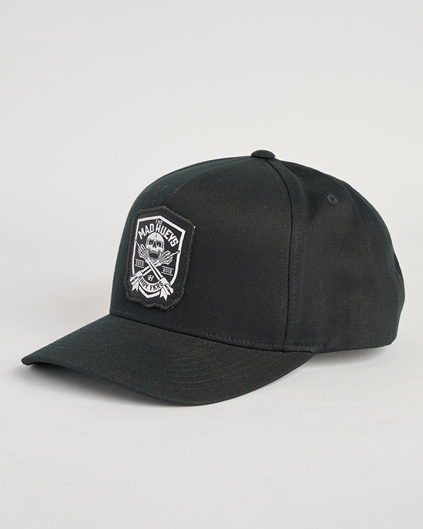 A black baseball cap featuring a "Mad Hueys" logo patch on the front with crossed anchors and bold text.