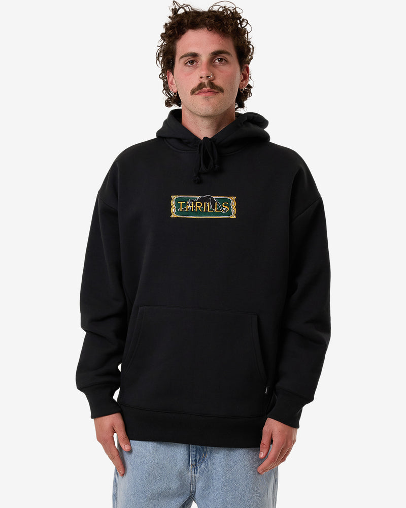 Black hoodie with a vintage-inspired 'THRILLS' logo patch on the chest, kangaroo pocket, and drawstring hood, worn by model.