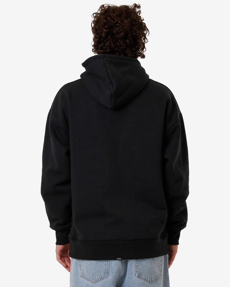 Back view of a black hoodie with a relaxed fit, oversized hood, and ribbed hem and cuffs, worn by a model with curly hair.