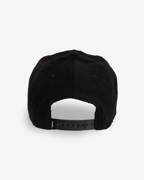 Black corduroy cap with an adjustable snapback closure at the back, featuring a small "Thrills" tag on the strap for branding.