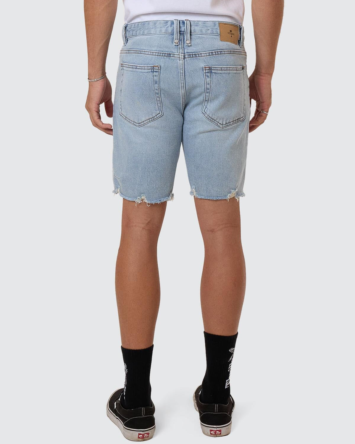 Back view light blue Thrills denim shorts with patch logo