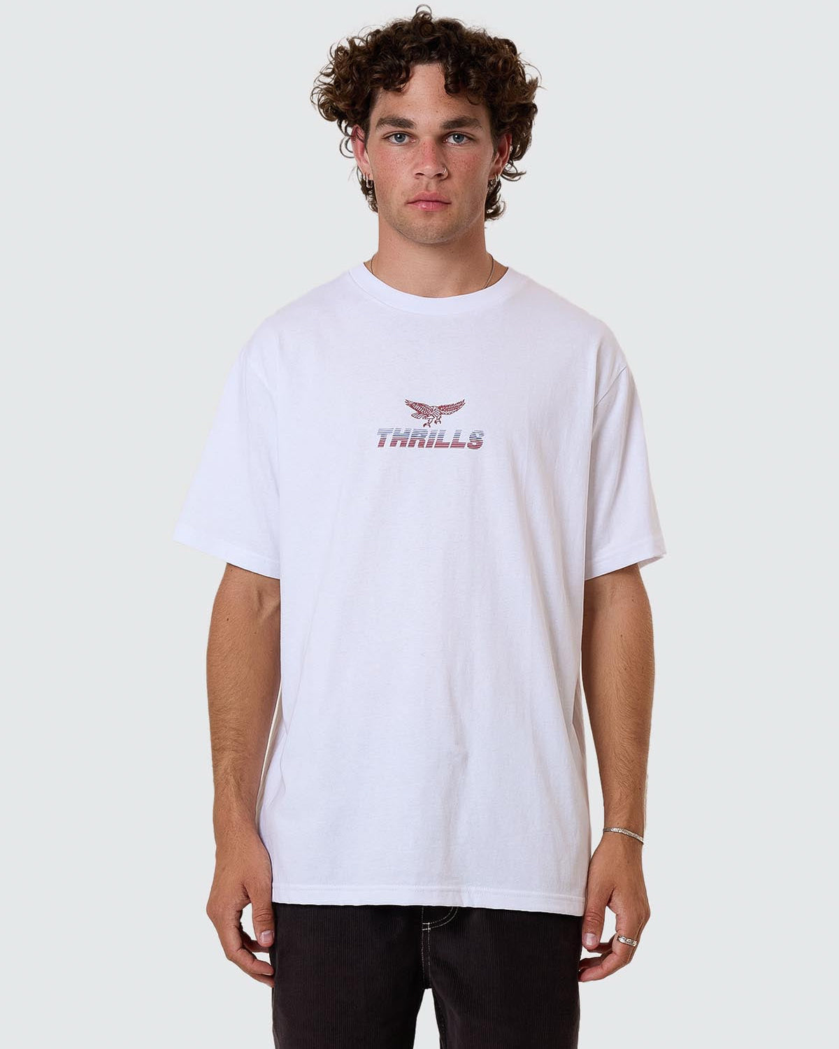 White oversized tee with small Thrills eagle logo on chest