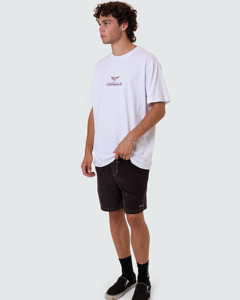 White oversized Thrills logo tee styled with black shorts and slip-on shoes