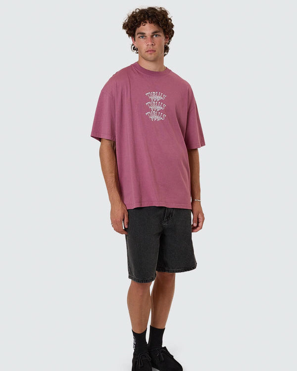 Pink Thrills graphic tee styled with black denim shorts