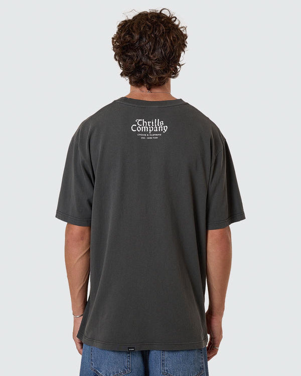 Faded black oversized tee with small Thrills Company logo on upper back