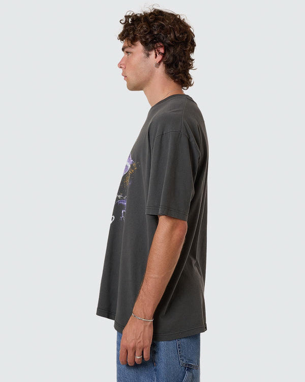 Side view of faded black oversized Thrills Company graphic tee