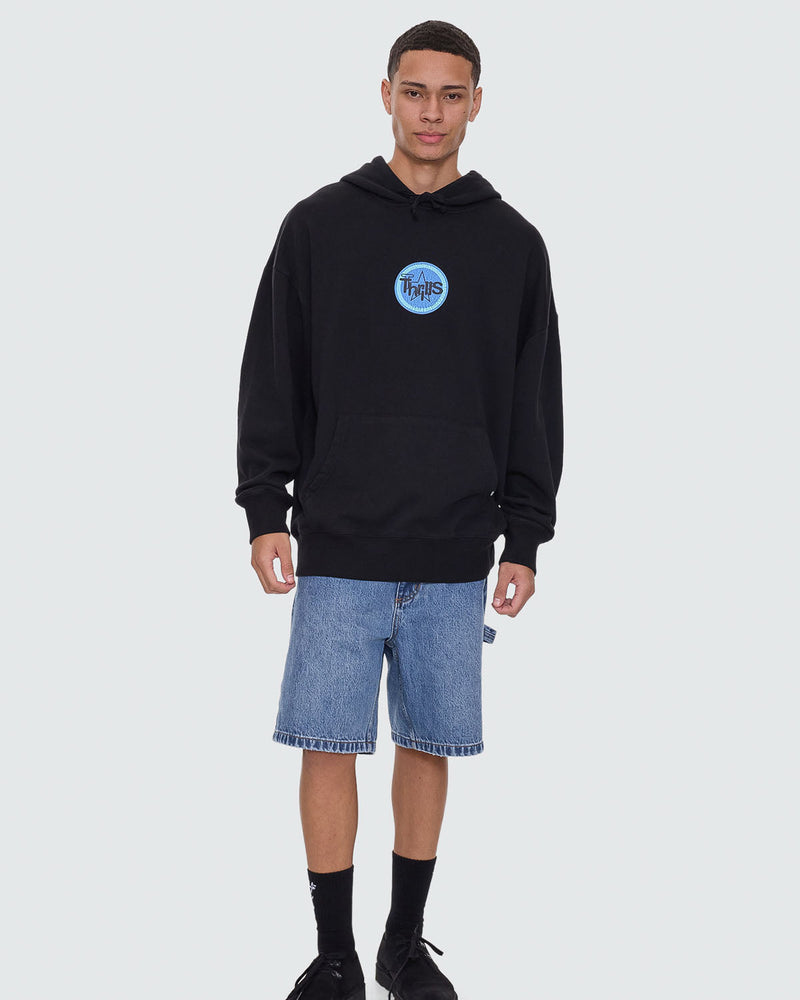 Black hoodie with blue Thrills chest logo, styled with blue denim shorts.