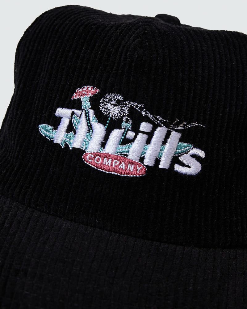 Close up embroidered Thrills Company logo with mushroom and dandelion design