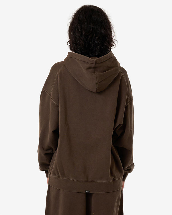 Back view of a female model wearing an oversized brown Thrills hoodie with a relaxed fit, large hood, and matching pants.