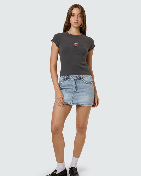 Black fitted graphic tee with denim mini skirt and black shoes
