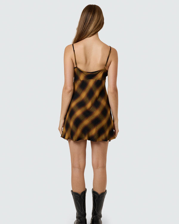 Back view of brown and black check satin slip dress.